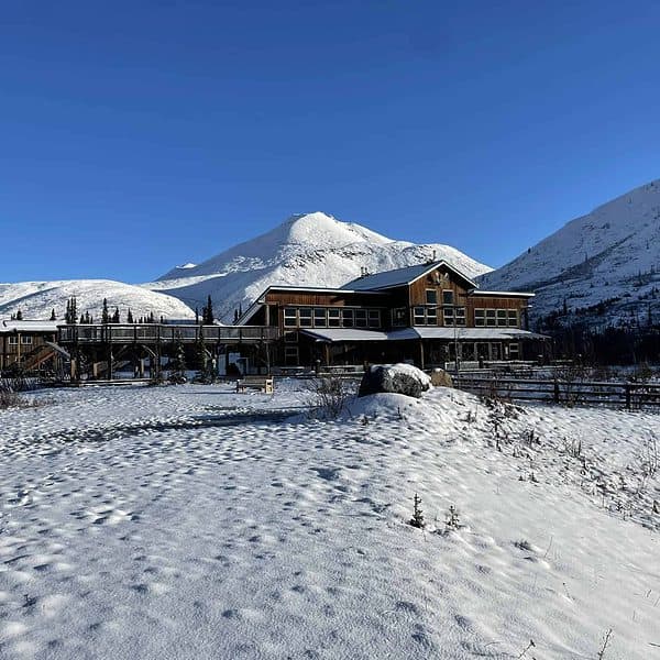 A building covered in snow in the mountains